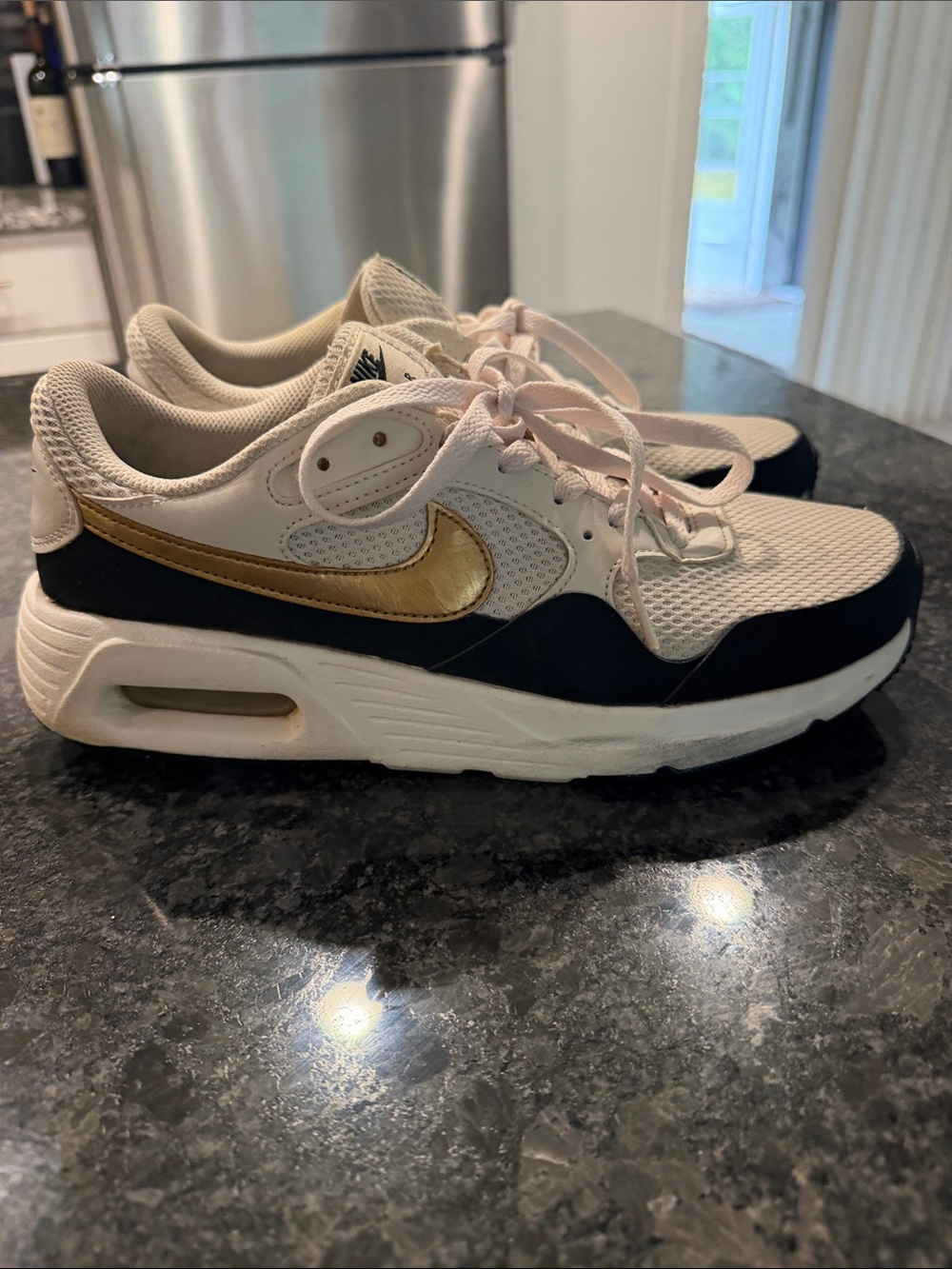 Nike Women’s White Mesh Sneakers with Gold Swoosh and Black Trim
